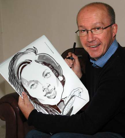 Caricaturist Paul with one of his portrait sketches